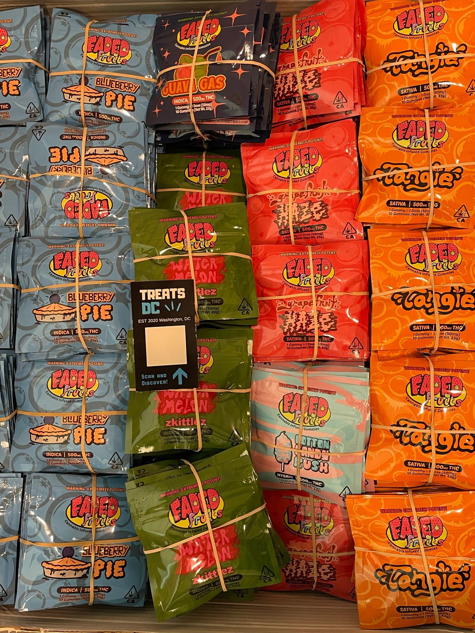 Bundles of Faded Fruits cannabis-infused gummies in various flavors.