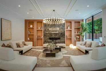 Elegant modern living room with white sofas and open shelves.
