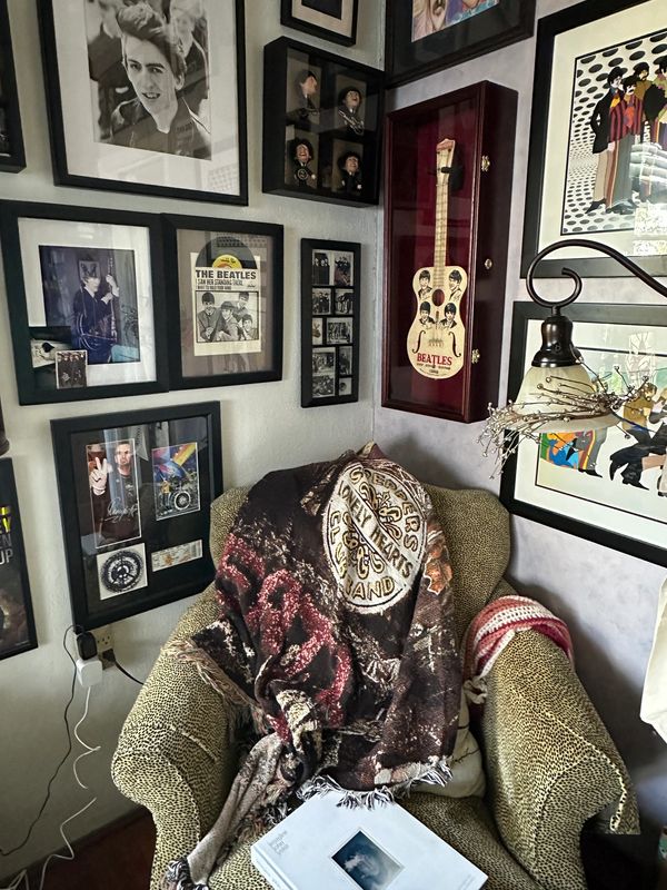 easy chair and Beatle pictures on wall 