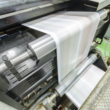 Printing press producing continuous sheets of paper.