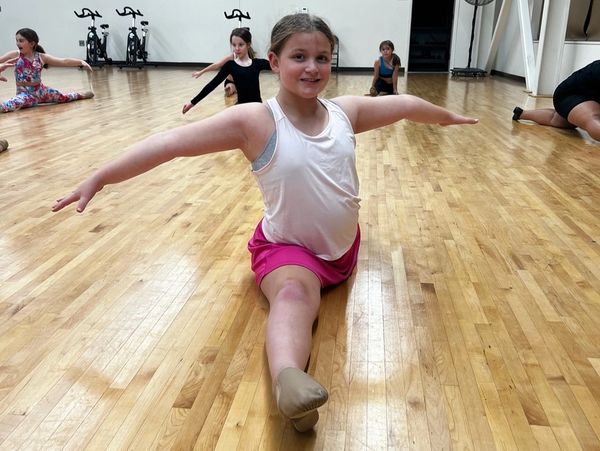 Dancer doing a split in dance class.