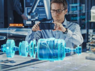 Engineer capturing a holographic 3D model of a mechanical device with a smartphone.