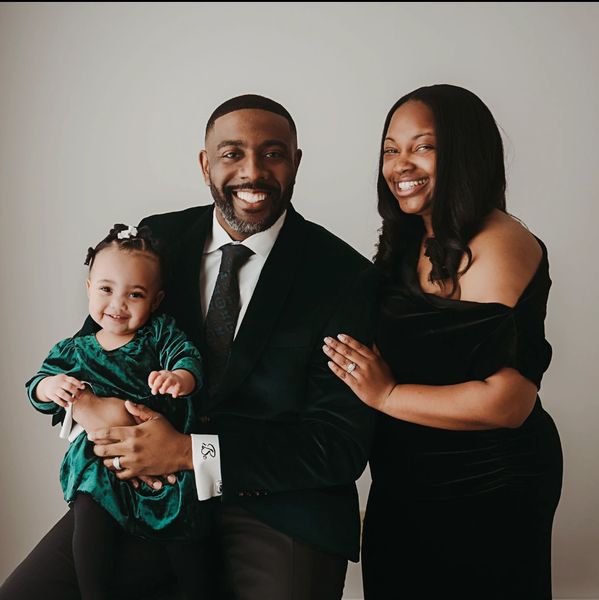 Happy family portrait with parents and baby.