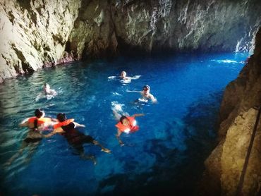 Our guests swimming in the Monk seal cave on our Blue cave tour