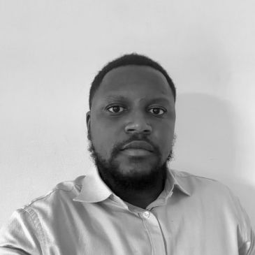 Black and white portrait of a man in a collared shirt.