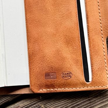 Close-up of a handmade leather item with American flag stamp.