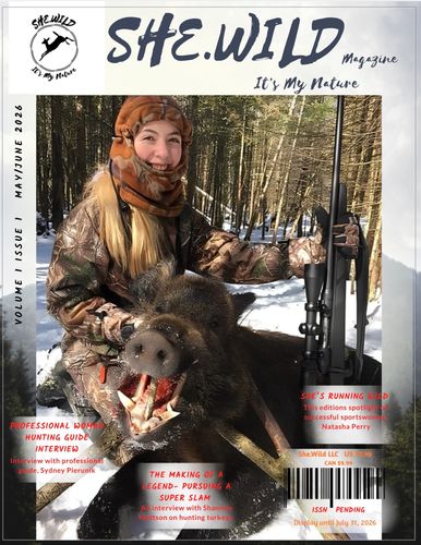 Woman hunter posing with a wild boar on SHE.WILD magazine cover.