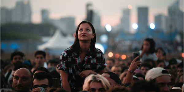 An audience member rises above the crowd 