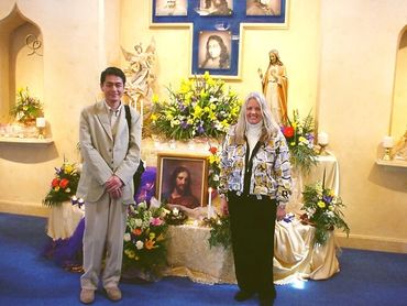 a man and a woman standing in front of an altar