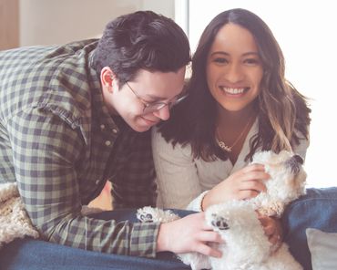 Couple playing with their dog