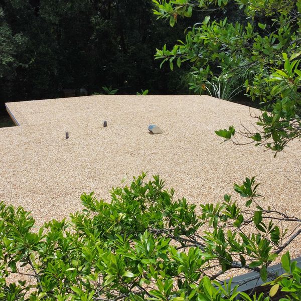 Close-up view of the edge of a new gravel built-up roof we recently installed.