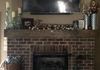 Mounted TV above mantle. Creates a great centerpiece for this fireplace.