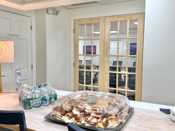 Tray of pretzel sandwiches and Poland Spring water on a table.