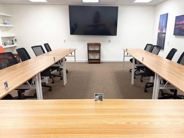 Empty conference room with tables and chairs.