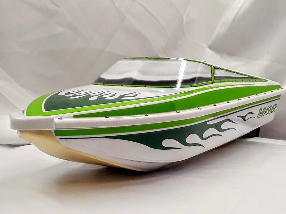 Green and white model speedboat with flame decals and clear cockpit.