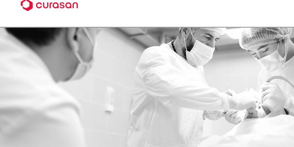 Medical professionals performing surgery in a sterile environment.