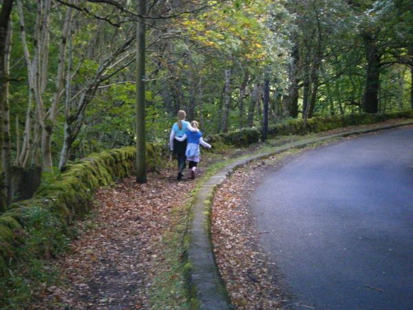 two girls walks throughout the forest