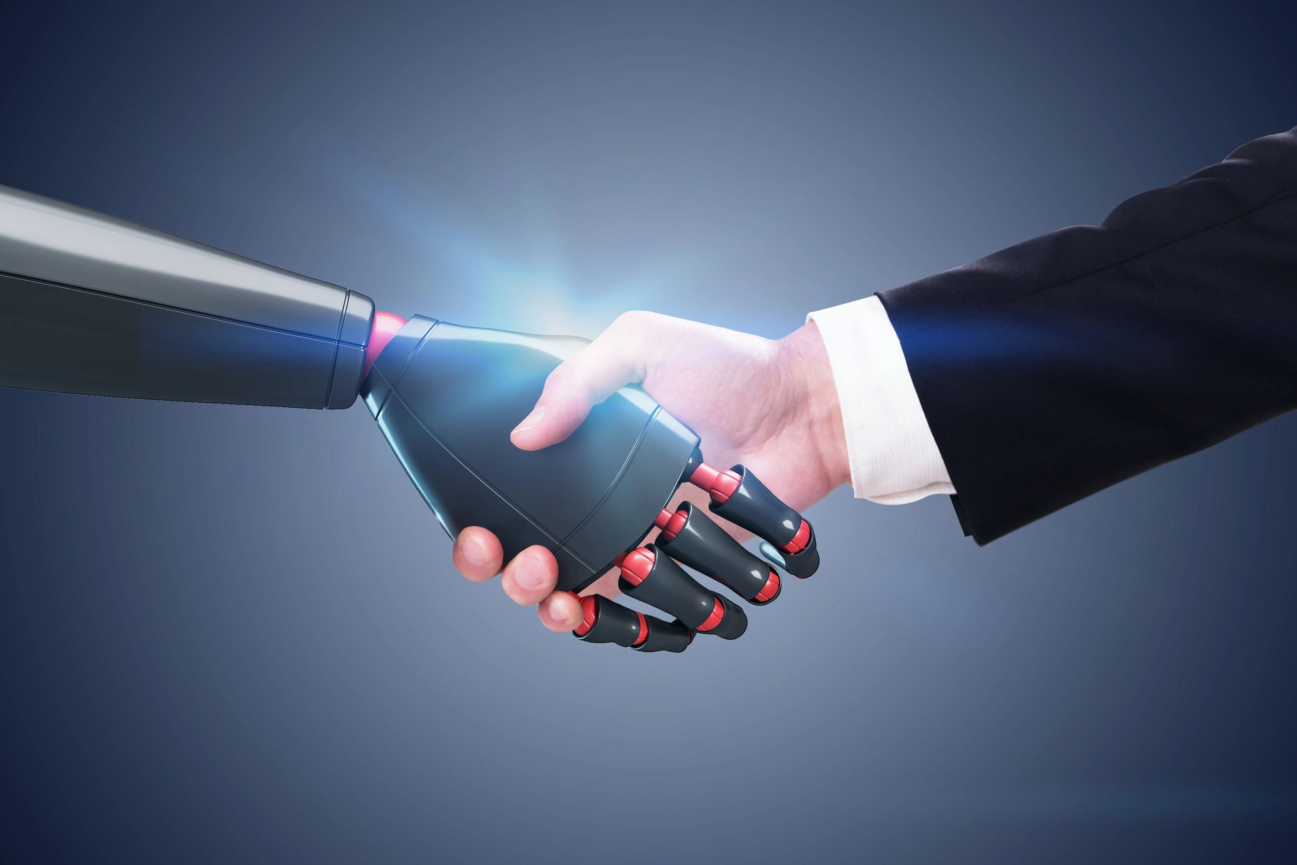 Human and robot handshake symbolizing partnership.