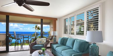Cozy living room with ocean view and balcony seating.