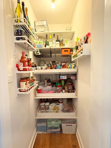 Organized pantry shelves stocked with drinks, snacks, and household items.