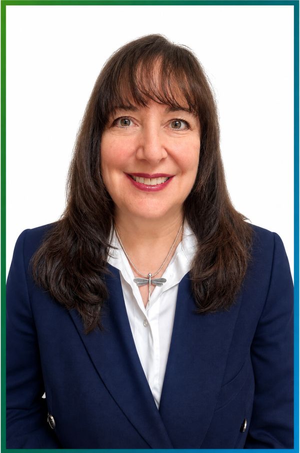 Professional woman smiling in a navy blazer.