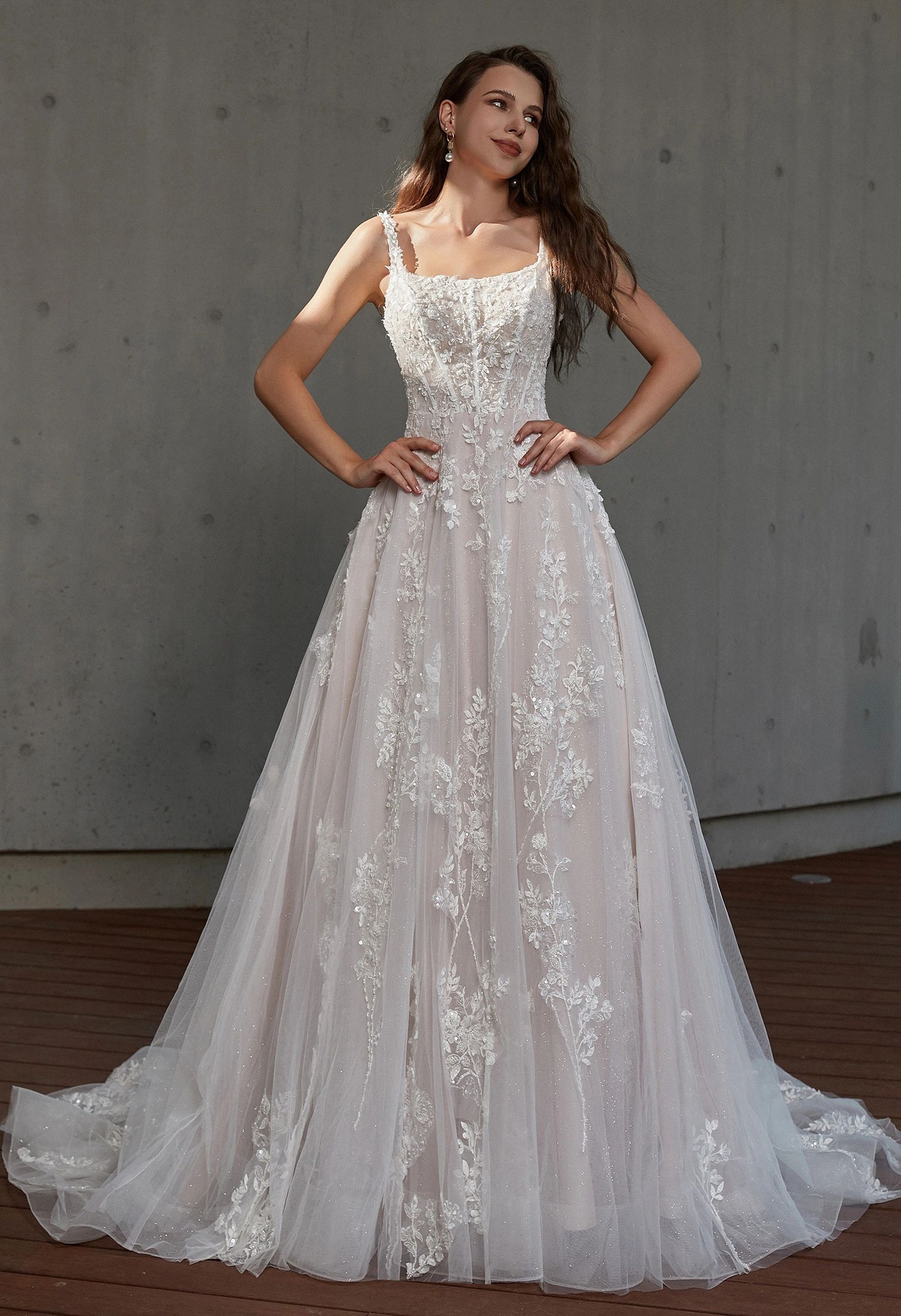 Bride in floral lace A-line wedding gown with square neckline and delicate straps, glitter tulle 