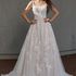Bride in floral lace A-line wedding gown with square neckline and delicate straps, glitter tulle 