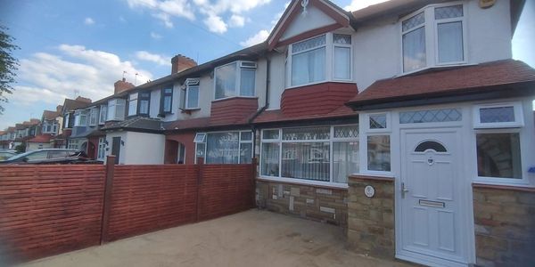 Terraced houses with red fencing and a white door.
