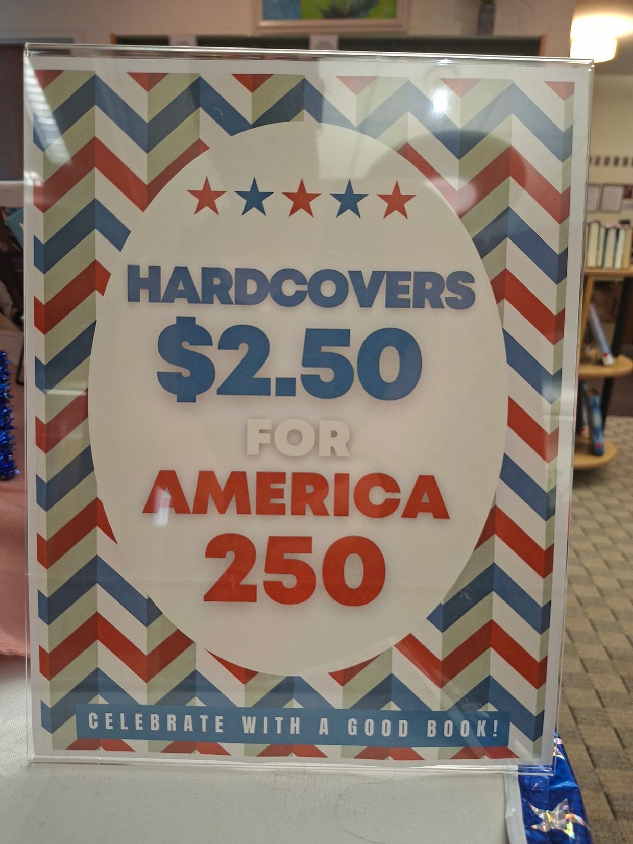 Sign advertising $2.50 hardcover books for America 250 celebration.