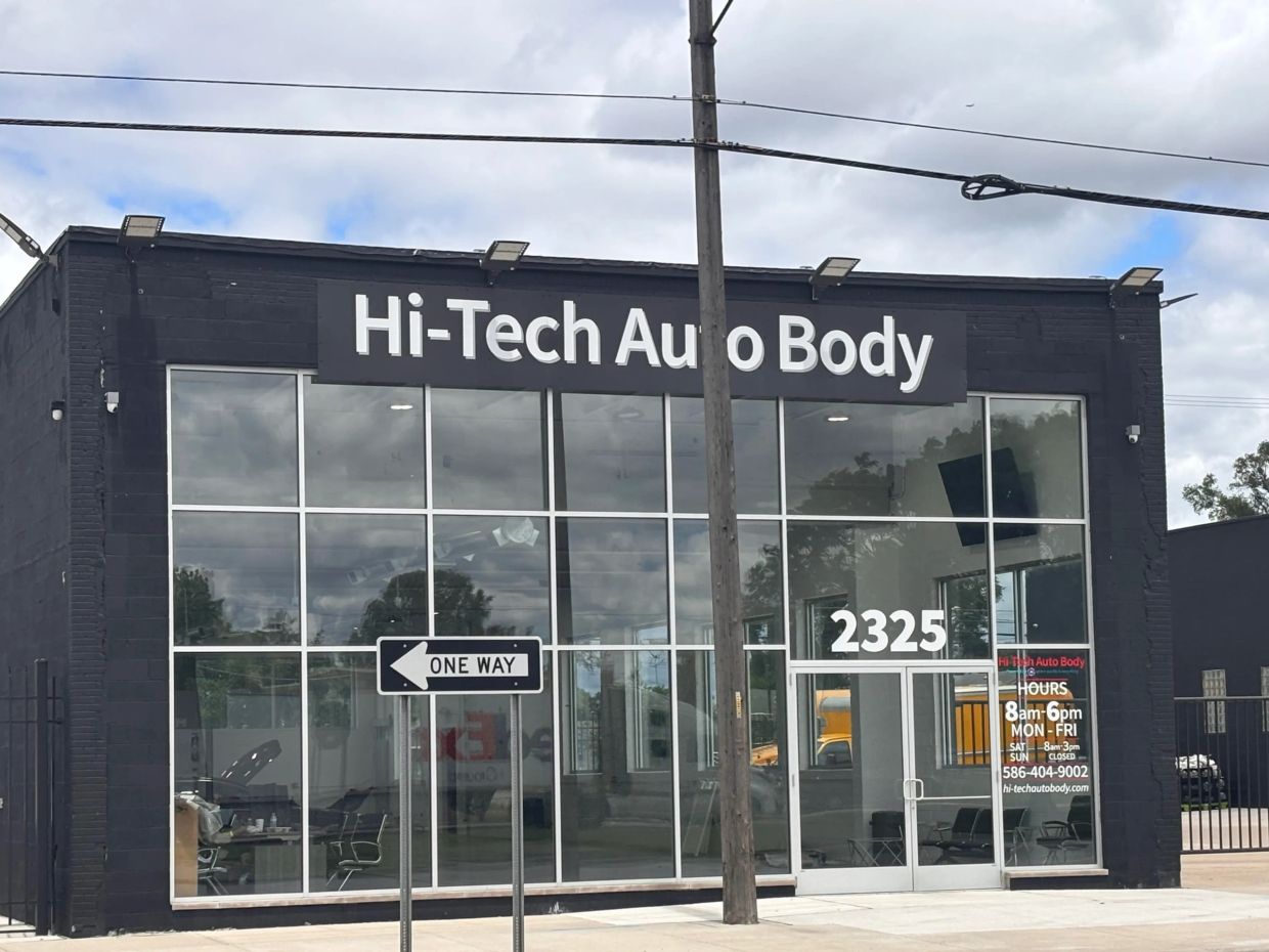 Auto body shop with a one-way street sign.