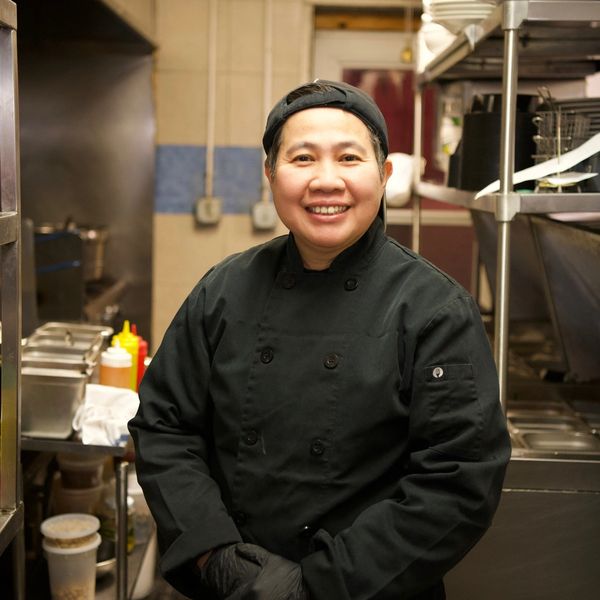 Thai chef standing in the kitchen of a commercial restaurant