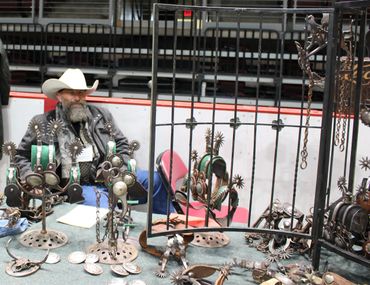 CCG Event Exhibitor & his display of Cowboy Collectible Merchandise