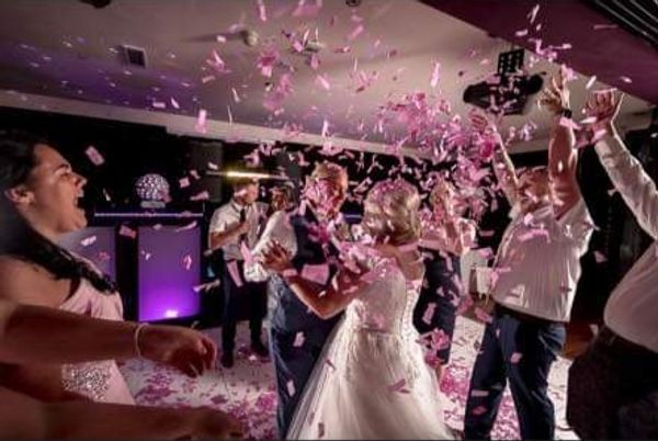 Couple celebrating with guests on the dance floor 