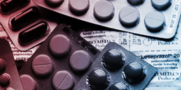 Various blister packs of pills on medical information sheets.