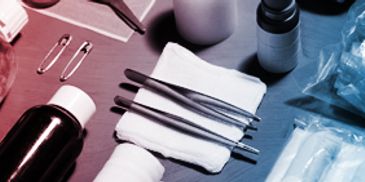 Sterile medical tools and supplies arranged on a table.