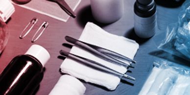 Medical tools and supplies arranged on a table for a procedure.