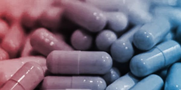 Close-up of red and blue capsules clustered together.