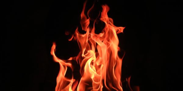 Bright orange flames against a black background.