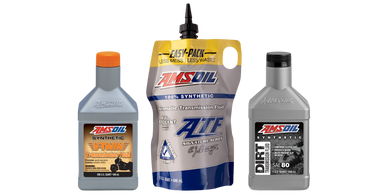 Three AMSOIL synthetic transmission fluid products in different containers.