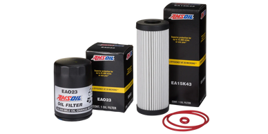 Two AMSOIL oil filters with their boxes and red rubber gaskets.