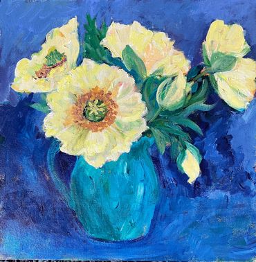 Yellow flowers in a blue vase against a blue background.