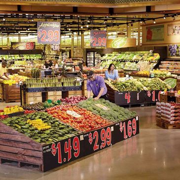 People shopping for fresh produce in a well lit with Promolux LED's grocery store.