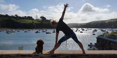 woman doing yoga near sea