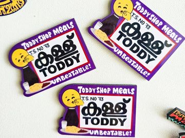 Three Toddy Shop Meals stickers with a yellow character and text in Malayalam and English.