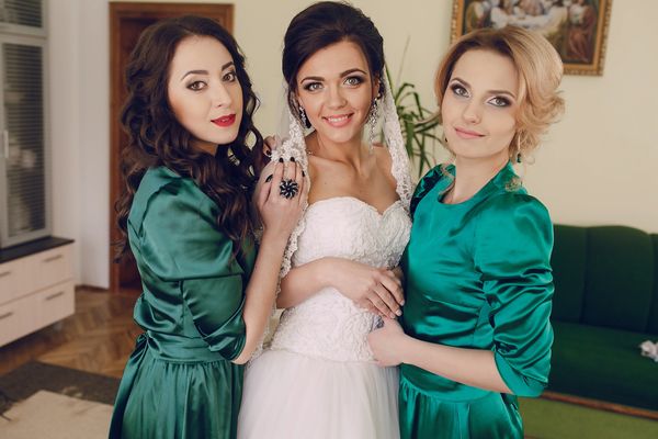 Bridesmaids & bride hugging 