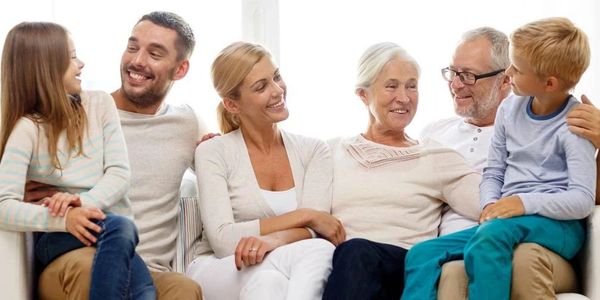 A happy multi-generational family sitting together and smiling.