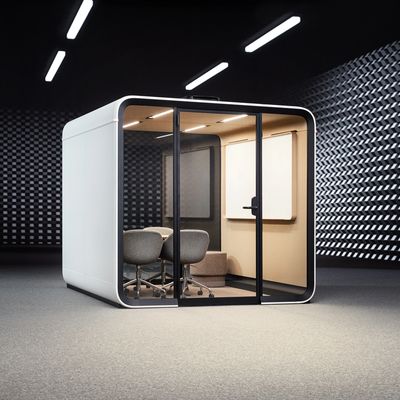 Modern, compact office pod with glass walls and gray chairs inside.