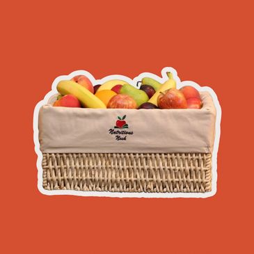 Wicker basket filled with assorted fresh fruits.
