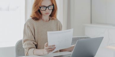 Bookkeeper reviewing financial records for monthly bookkeeping services