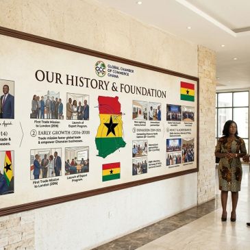 Woman standing near a history and foundation wall display.